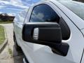 A 2019 Chevrolet Silverado 1500 pickup truck with a prominent side mirror showcasing a sleek design and integrated turn signal lights