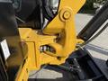 Close-up of the hydraulic arm and attachment of a 2022 Caterpillar 306 excavator showcasing its yellow and black components and mechanical design