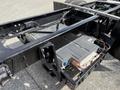 A close-up view of the chassis of a 2022 Lion Lion6 electric vehicle featuring a battery pack mounted on the frame with electrical components and wiring visible