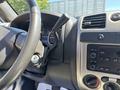 Dashboard and steering wheel of a 2011 Chevrolet Colorado with controls for audio and climate settings visible