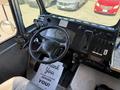 Interior view of a 2009 Morgan Olson Workhorse W62 with a steering wheel dashboard controls and a thank you mat on the floor