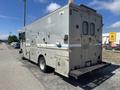 A silver 2009 Workhorse W62 truck with multiple compartments and vents on the side visible from the rear angle