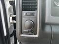 Control panel with knobs and switches for lighting and ventilation in a 2013 RAM 5500