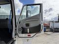 A side view of an open door on a 2022 Lion Lion6 truck showcasing the interior handle and design elements