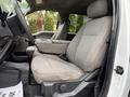 Interior of a 2020 Ford F-550 showing two front seats with fabric upholstery and a center console in between