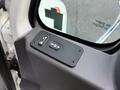 Close-up of a control panel in a 2011 International WorkStar featuring two buttons for locking and unlocking the door