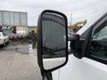 A side mirror of a 2013 Chevrolet Silverado 3500HD with visible water droplets on its surface