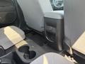 Interior of a 2017 Chevrolet Colorado showing the rear seating area with fabric seats and a center console featuring cup holders and storage compartments