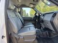 Interior of a 2011 Ford F-550 featuring gray leather front seats and a dashboard with controls and gauges visible