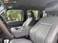 Interior of a 2014 Ford F-550 showing grey leather seats and a center console with cup holders