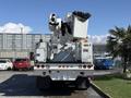 A white 2008 International 7500 bucket truck with an elevated lift mechanism and arm ready for aerial work