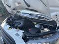 The engine compartment of a 2019 Ford Transit 350 with the hood open showing the engine components and various fluids