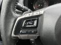 Close-up of the steering wheel controls in a 2016 Subaru Forester featuring buttons for audio source volume and phone functions