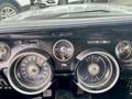 The dashboard of a 1968 Ford Mustang Two Door Convertible featuring vintage gauges for speed, fuel, and alternator indicators