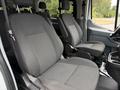 Two front seats of a 2017 Ford Transit T150 XLT van with fabric upholstery featuring vertical stripes and armrests