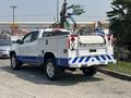 A 2017 Chevrolet Colorado with a white and blue color scheme featuring a utility bed and rear equipment storage compartments