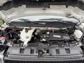 A 2020 Chevrolet Express engine compartment with visible components including the engine block battery coolant reservoir and various hoses and wiring