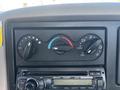 Dashboard controls of a 2013 International 7500 featuring climate control knobs and a CD player interface