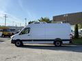 A white 2016 Mercedes-Benz Sprinter van is parked sideways with a tall roof and black trim along the bottom