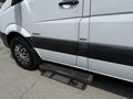 A 2016 Mercedes-Benz Sprinter van with a silver and black exterior featuring a side step and alloy wheels