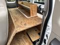 Interior view of a 2008 Ford F-250 SD with a wooden platform and shelving installed in the truck bed