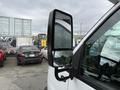 A side mirror of a 2013 Chevrolet Express showing the reflective surface and mounting bracket