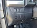Control panel of a 2018 Toyota Highlander featuring buttons for auto, traction control, and tailgate functions