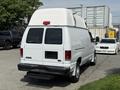 A white 2008 Ford Econoline van with a high roof and rear doors showing no visible license plate