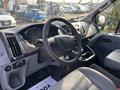 A 2016 Ford Transit 150 van's interior featuring a steering wheel and dashboard with controls and a gear shift area