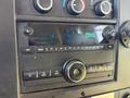 Dashboard of a 2020 Chevrolet Express showing controls for audio and climate with a digital clock display