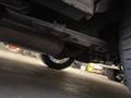 A 1968 Ford Mustang viewed from underneath showcasing the exhaust system and rear suspension components