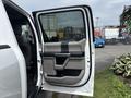 Interior door of a 2017 Ford F-150 featuring a sleek design with a handle and armrest in a contrasting color scheme