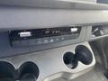 The interior dashboard control panel of a 2024 Mercedes-Benz Sprinter featuring climate controls and cup holders