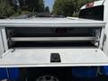 A 2017 Chevrolet Colorado with an open bed cover revealing storage space inside