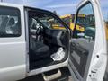 2014 Ford F-250 SD with an open driver's door showcasing the interior features including seats and dashboard