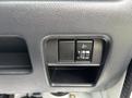 A control panel featuring buttons for headlights and fog lights in a 2010 Suzuki Carry vehicle