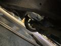A 1968 Ford Mustang viewed from beneath highlighting the underside and components including the rear axle and suspension parts