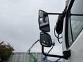 A 2013 Freightliner 114SD truck featuring dual side mirrors in focus with a reflection visible on the glass