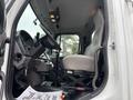 Interior view of a 2013 Freightliner 114SD showing the driver's seat dashboard and steering wheel