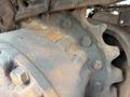 Close-up of a rusty gear and cog system on a 2018 Caterpillar 326F L Excavator showcasing detailed metal components and bolts