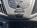 Dashboard controls of a 2019 Ford Transit 350 featuring media and menu buttons a passenger airbag indicator and climate control knobs