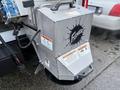 A 2023 Ford F-250 equipped with a Fisher snowplow attachment featuring a sleek metal design and warning labels