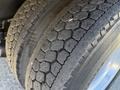 Close-up of the tire tread on a 2011 Freightliner M2 106 showing a hexagonal pattern with visible wear and dirt