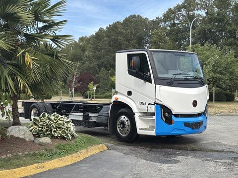 A 2020 Lion Lion6 electric truck in white and blue with a cab and chassis design parked at an angle