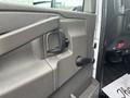 Interior view of the door handle and window crank of a 2020 Chevrolet Express van