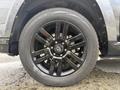 A close-up of a black alloy wheel on a 2021 Toyota 4Runner featuring a Yokohama tire with a geometric tread design