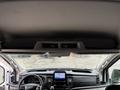 Interior view of a 2020 Ford Transit 250 dashboard showing steering wheel control panel and infotainment screen