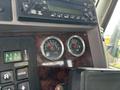 Dashboard of a 2013 Kenworth T370 displaying fuel and DEF gauges with a digital monitor and controls