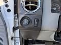 A close-up of the interior controls of a 2012 Ford F-350 SD featuring knobs for air conditioning and headlights along with a gauge panel
