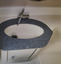A 2013 Larson 238 boat's sleek, oval sink with a polished faucet and a granite-style countertop